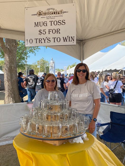 Photo of United Way volunteers working the mug toss game at Oktoberfest