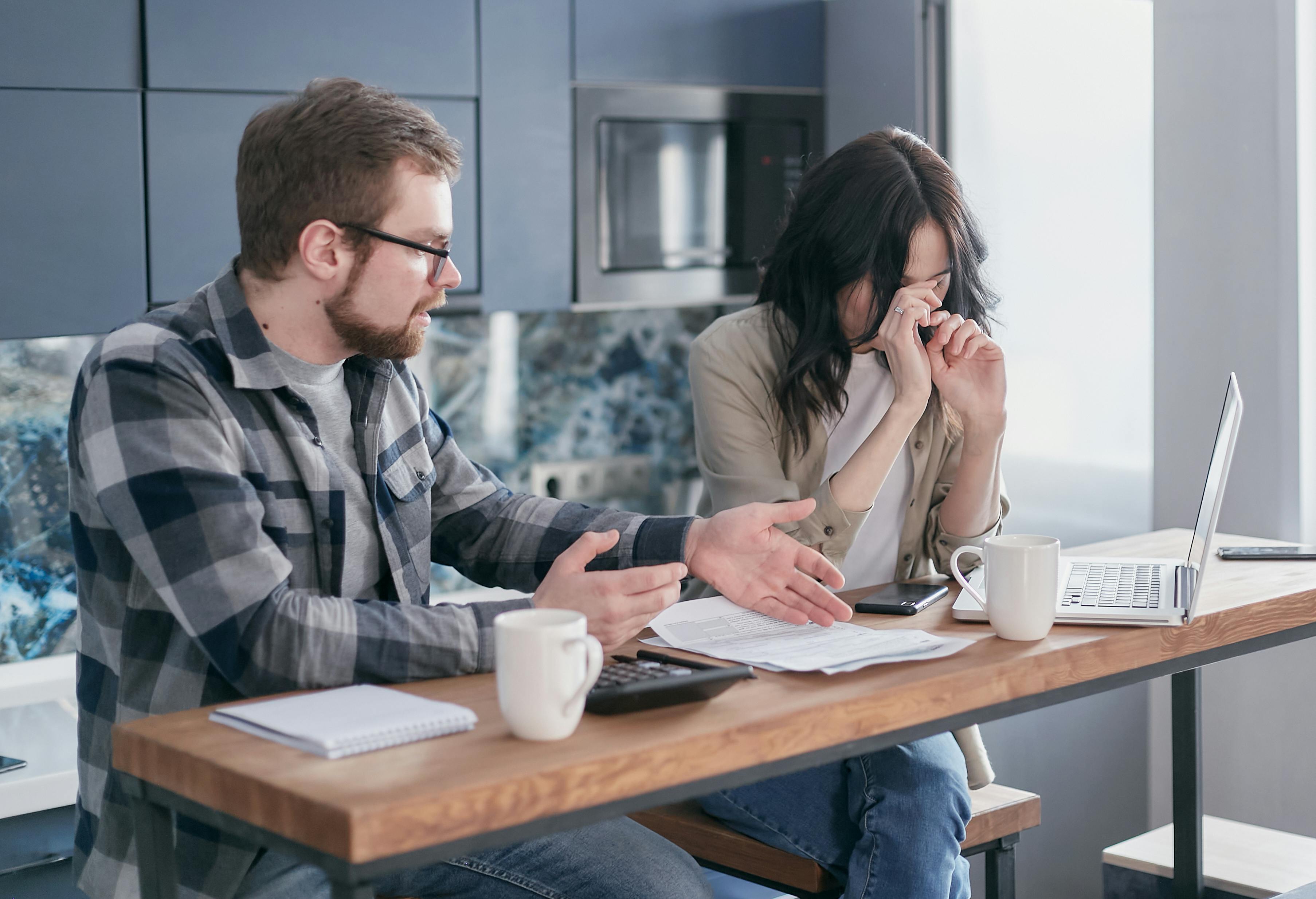 photo of a couple discussing their bills.