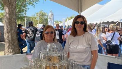 Photo of United Way volunteers working the mug toss game at Oktoberfest