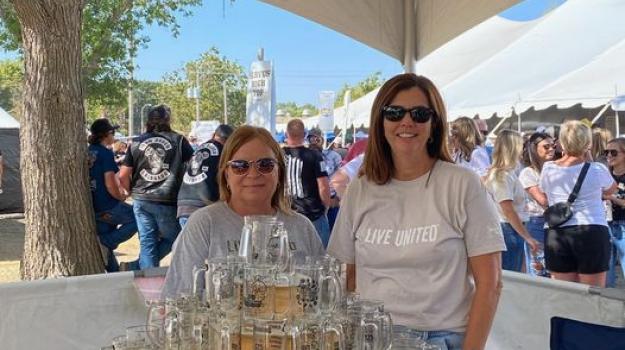 Photo of United Way volunteers working the mug toss game at Oktoberfest